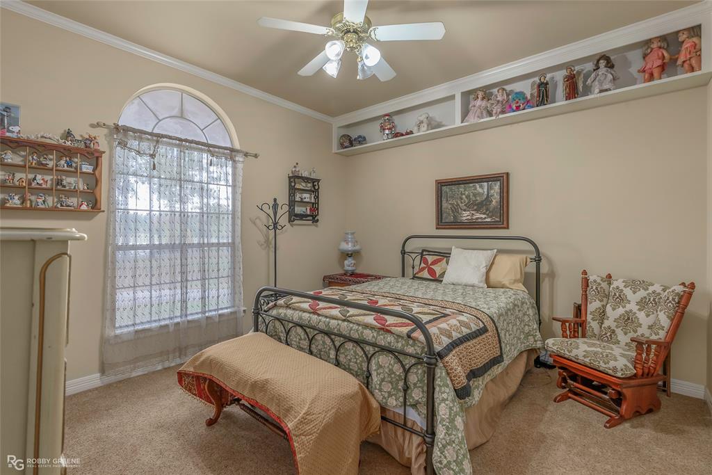 400 Crouch Road Benton, LA 71006 - Photo 20 of 40 Kitchen featuring brown cabinetry, tasteful backsplash, appliances with stainless steel finishes, dark stone countertops, and a wooden ceiling with exposed beams