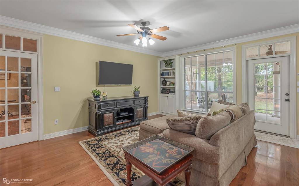 400 Crouch Road Benton, LA 71006 - Photo 30 of 40 a living room with furniture a flat screen tv and a fireplace