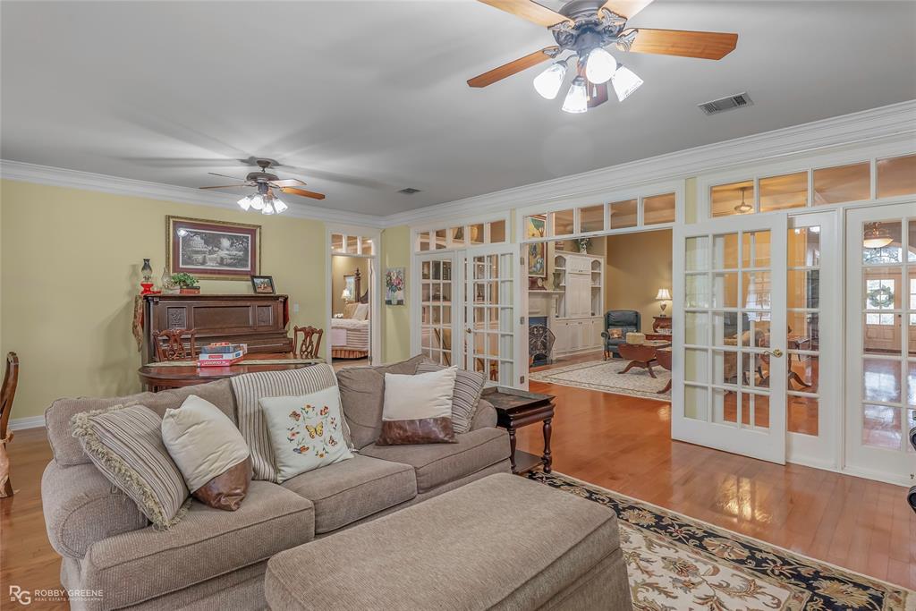 400 Crouch Road Benton, LA 71006 - Photo 32 of 40 Living area with crown molding, light wood-type flooring, and a ceiling fan