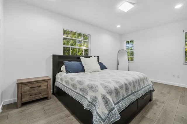 a bed sitting in a bedroom next to a window