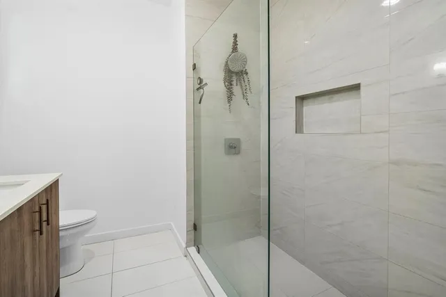 a bathroom with a shower and a toilet