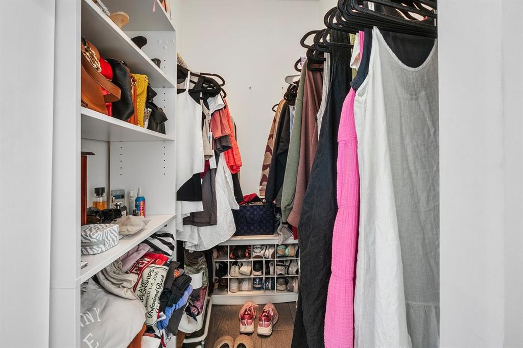 1030 Crystal Way, Unit 104 Delray Beach, FL 33444 - Photo 17 of 44 a view of walk in closet with clothes and shoes