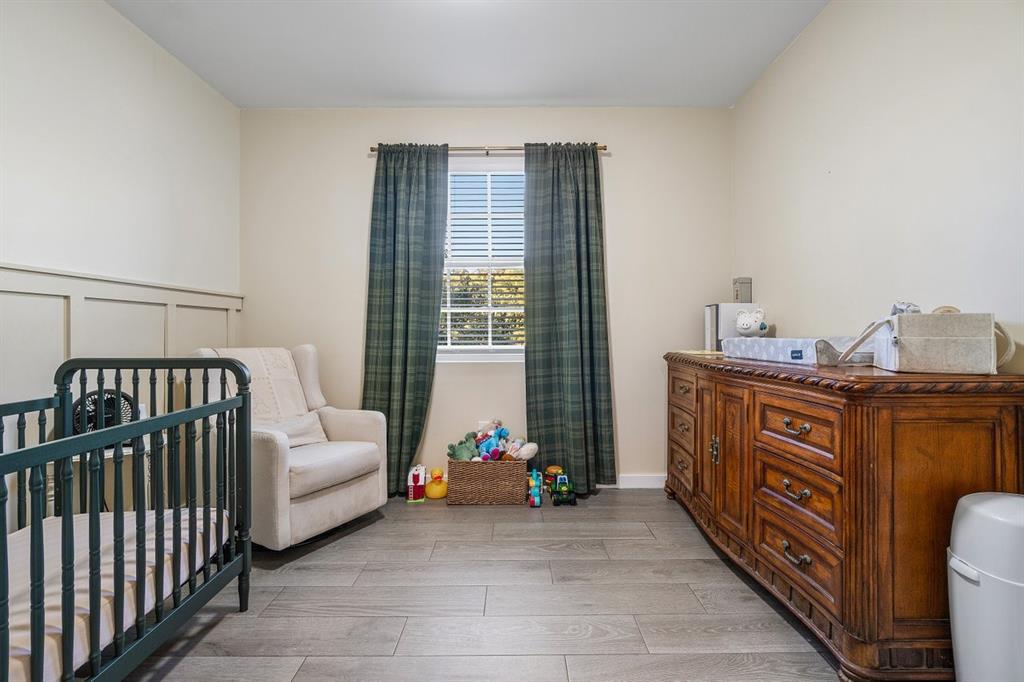 1030 Crystal Way, Unit 104 Delray Beach, FL 33444 - Photo 19 of 44 a bedroom with furniture and a window