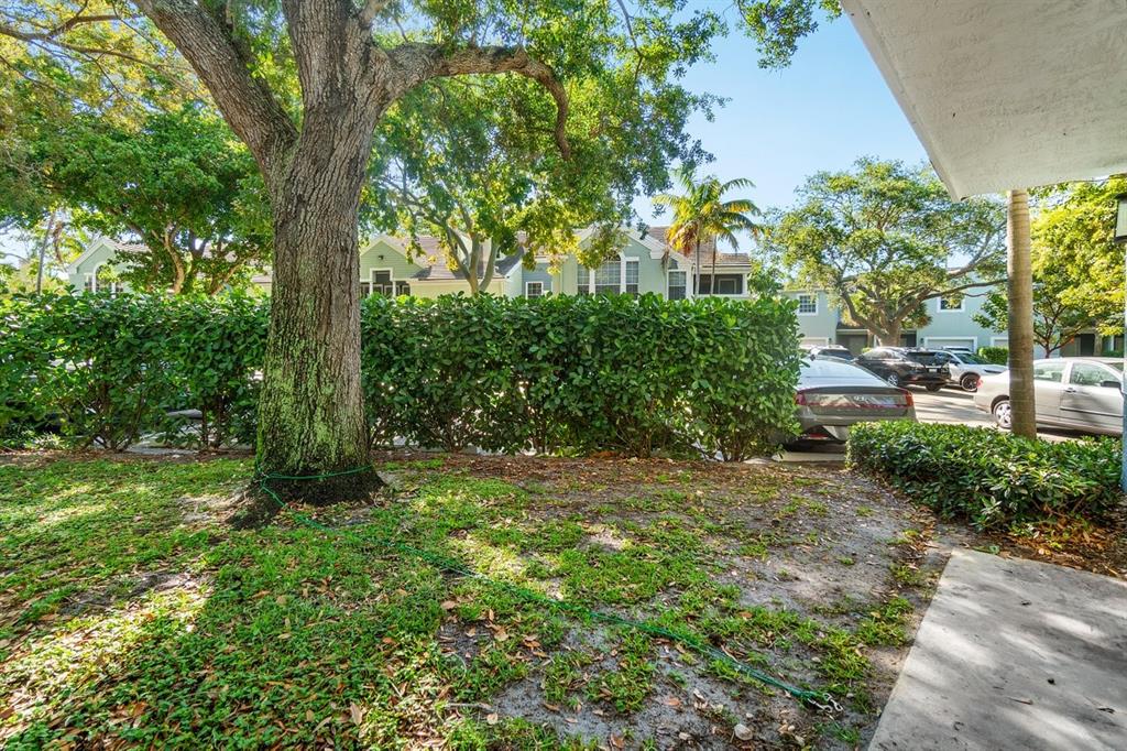 1030 Crystal Way, Unit 104 Delray Beach, FL 33444 - Photo 25 of 44 a view of a yard with large trees