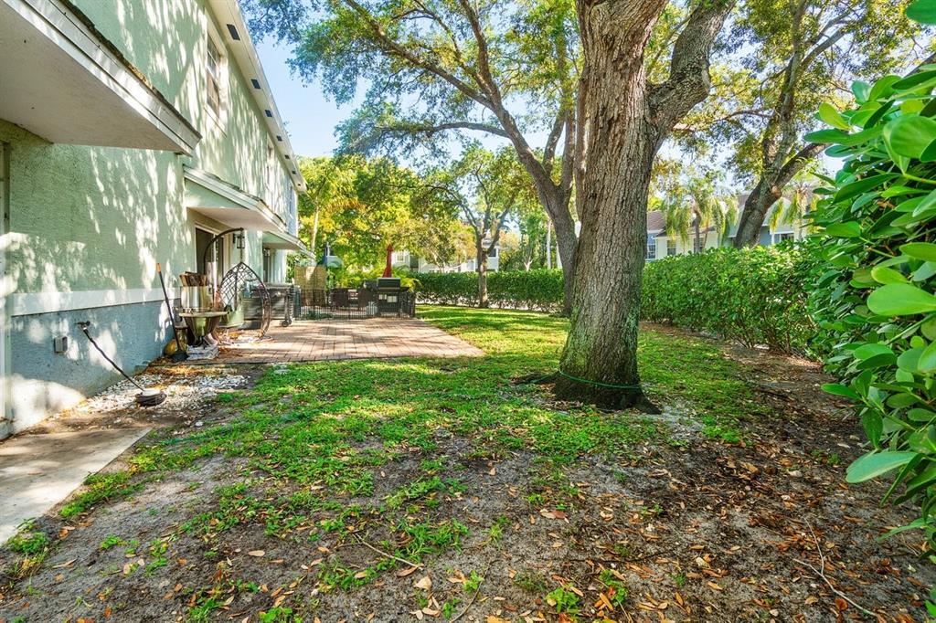 1030 Crystal Way, Unit 104 Delray Beach, FL 33444 - Photo 26 of 44 a view of backyard of house with green space