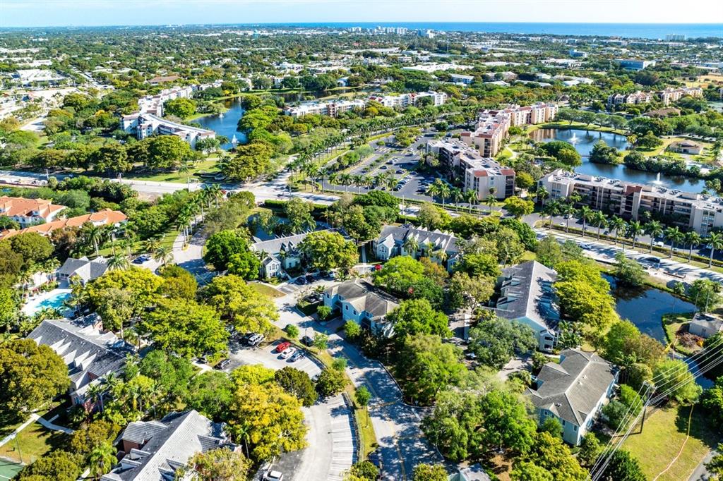 1030 Crystal Way, Unit 104 Delray Beach, FL 33444 - Photo 3 of 44 an aerial view of residential houses with outdoor space and trees