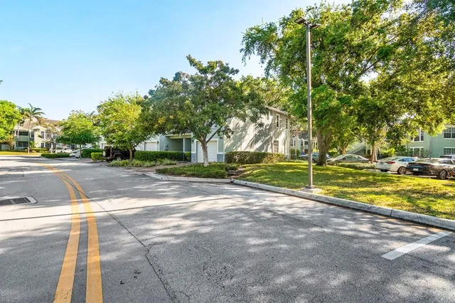 an aerial view of residential houses with outdoor space and trees