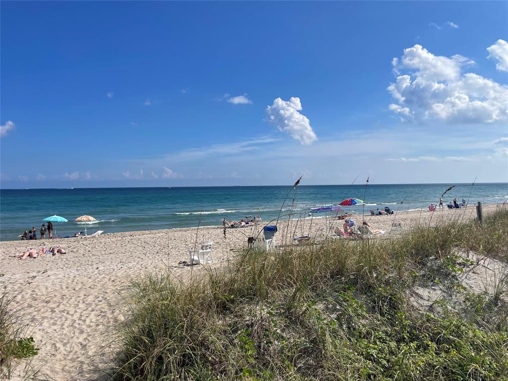 1030 Crystal Way, Unit 104 Delray Beach, FL 33444 - Photo 40 of 44 a view of a swimming pool and an outdoor space