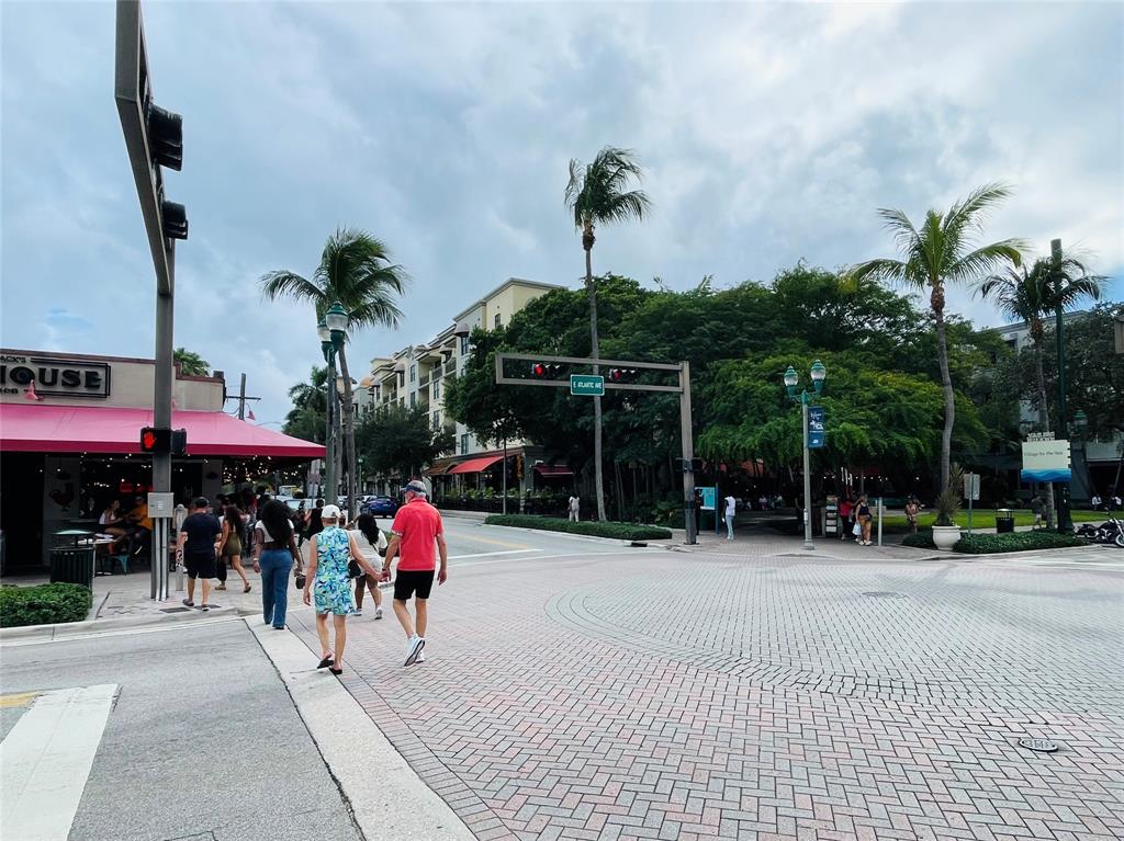 1030 Crystal Way, Unit 104 Delray Beach, FL 33444 - Photo 42 of 44 a group of people sitting in front of retail shop