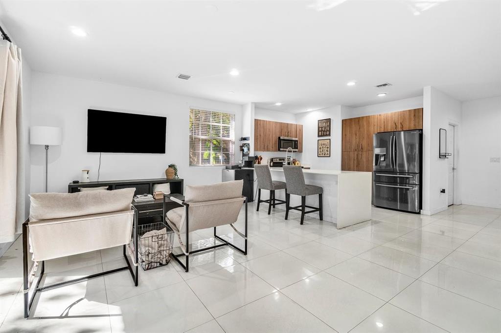 1030 Crystal Way, Unit 104 Delray Beach, FL 33444 - Photo 7 of 44 a living room with furniture and a flat screen tv