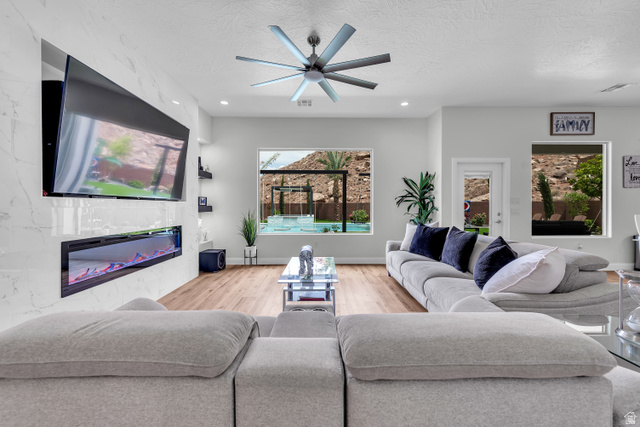 6105 Bunda Way St. George, UT 84790 - Photo 7 of 49 Living area featuring wood-finish flooring, recessed lighting, and a contemporary ceiling fan