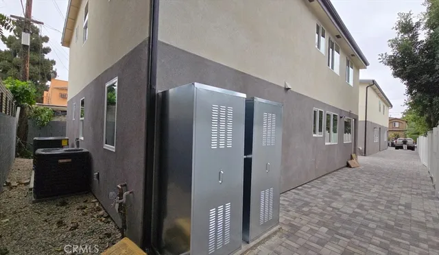 a view of a house with a door and wooden bench