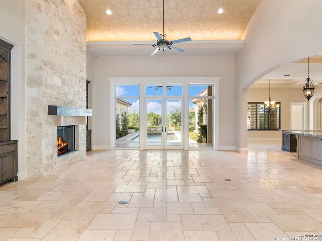 a large kitchen with kitchen island granite countertop a sink and a counter top space