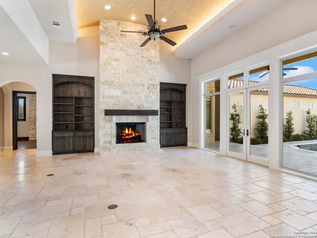 a large bathroom with a granite countertop sink a toilet a mirror and vanity