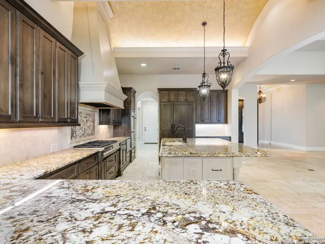 an empty room with wooden floor a ceiling fan and windows