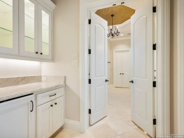 a bathroom with a granite countertop toilet a sink a mirror and a shower