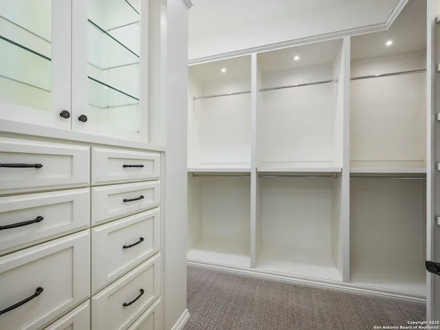 a view of a hall with a fireplace and potted plants