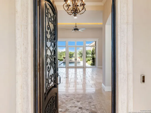 en empty room with wooden floor and chandelier