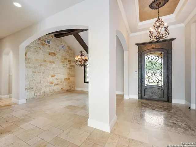 a view of an empty room with a fireplace and a window