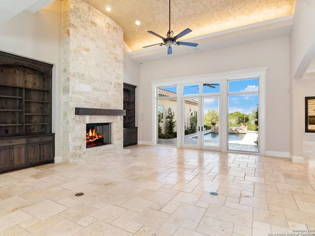 a view of an empty room with a fireplace and a window