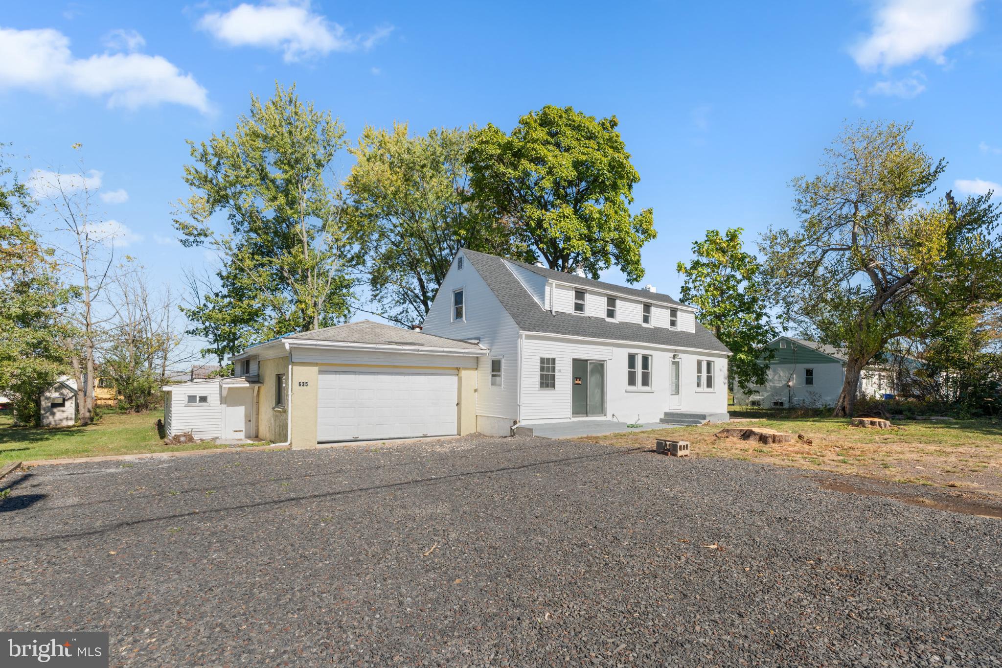 Charming home with spacious yard and trees.