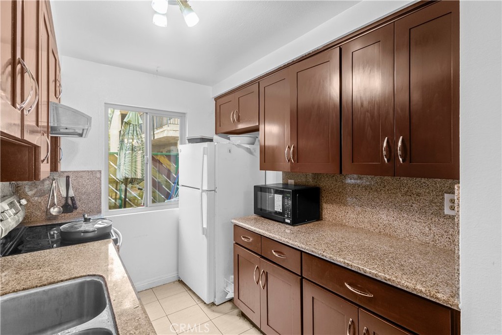 1791 Neil Armstrong Street, Unit 103 Montebello, CA 90640 - Photo 15 of 33 a kitchen with a refrigerator and a sink