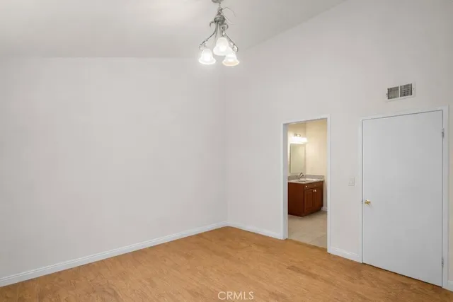 a view of a room with wooden floor and windows
