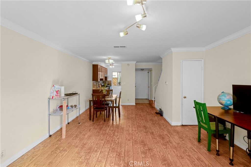 1791 Neil Armstrong Street, Unit 103 Montebello, CA 90640 - Photo 9 of 33 a dining room with furniture and wooden floor
