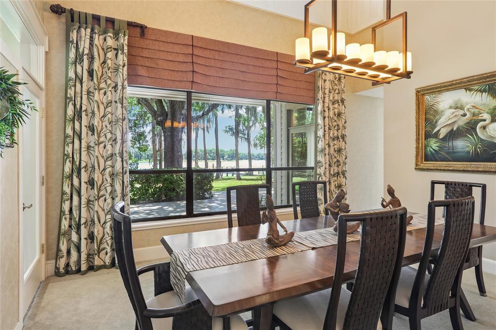 17810 Crawley Road Odessa, FL 33556 - Photo 14 of 76 a view of a dining room with furniture large windows and wooden floor