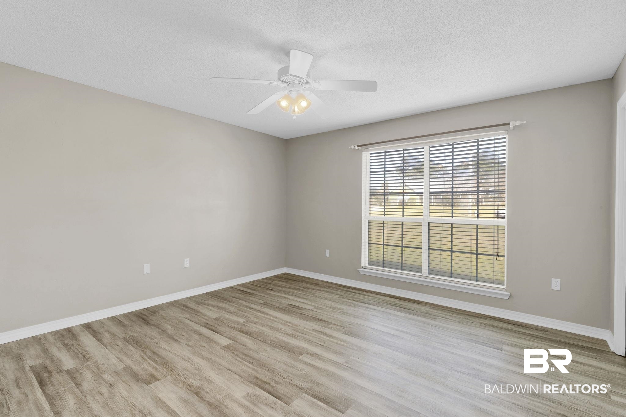 10238 Grove Drive Fairhope, AL 36532 - Photo 22 of 39 Bedroom featuring light wood-type flooring, ceiling fan, large closet.