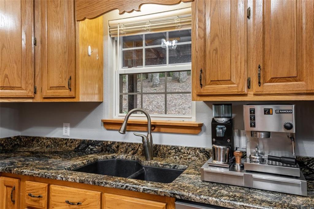 349 Moon Shadow View North Blairsville, GA 30512 - Photo 17 of 74 a kitchen with granite countertop a sink and a stove