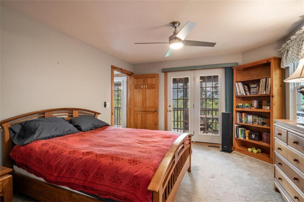 349 Moon Shadow View North Blairsville, GA 30512 - Photo 20 of 74 a bed sitting in a bedroom next to a book shelf