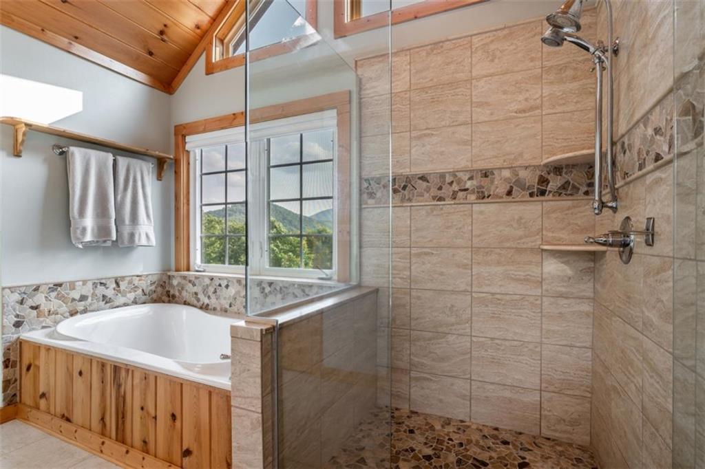 349 Moon Shadow View North Blairsville, GA 30512 - Photo 45 of 74 a bathroom with a bathtub and shower