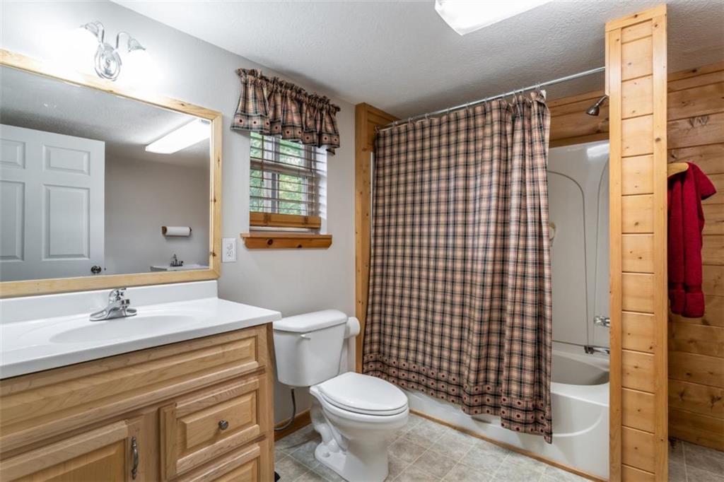 349 Moon Shadow View North Blairsville, GA 30512 - Photo 50 of 74 a bathroom with a sink toilet vanity and shower