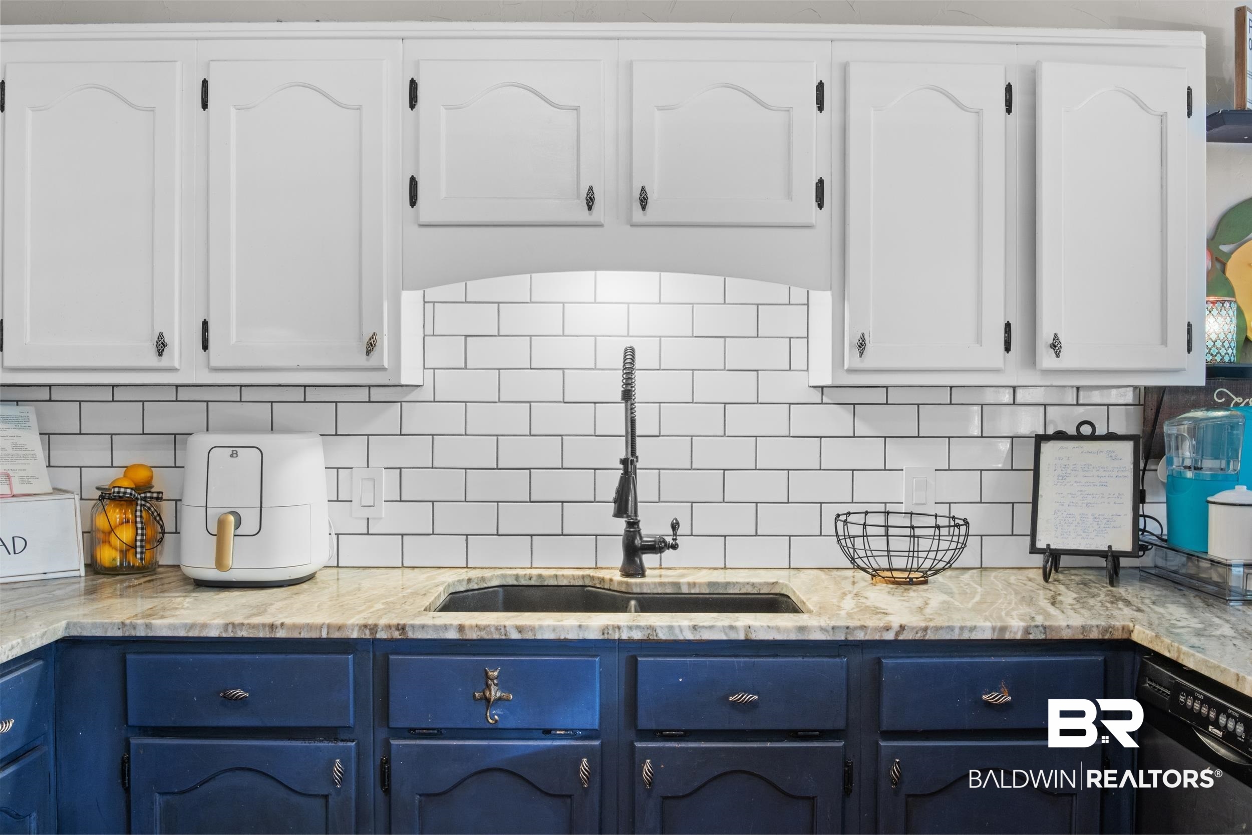 131 Marikesh Drive Daphne, AL 36526 - Photo 13 of 29 Kitchen with sink, blue cabinetry, white cabinetry, black dishwasher, and decorative backsplash