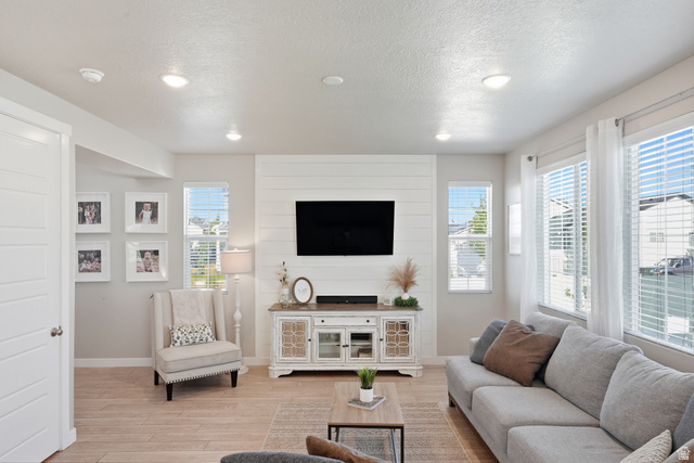 3244 West 1670th Street North Provo, UT 84601 - Photo 10 of 56 Spacious living area featuring wood-finish flooring, recessed lighting, and large windows with blinds