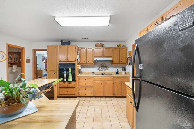 a kitchen with stainless steel appliances a refrigerator sink and stove