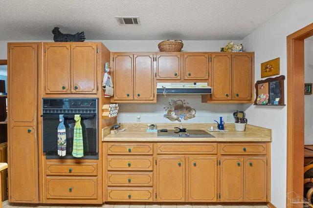 a kitchen with granite countertop cabinets and window