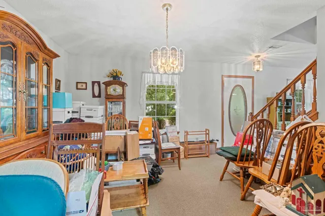 a living room filled with furniture and a chandelier