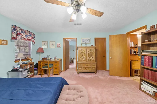 a bedroom with furniture and a flat screen tv