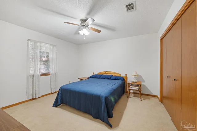 a bedroom with bed and flat screen tv
