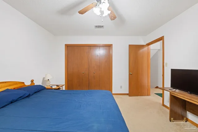 a view of a hallway with closet and couch