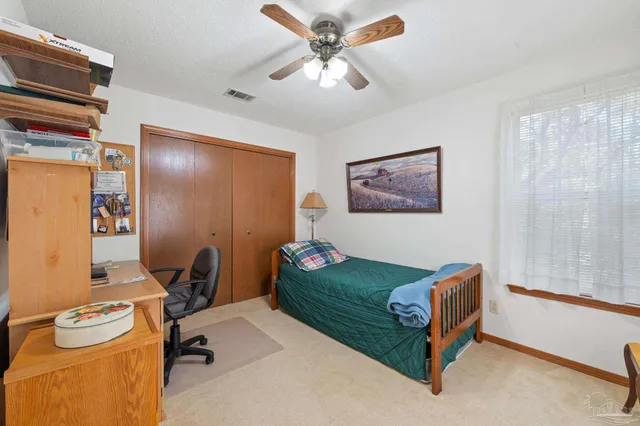 a view of a workspace with furniture and a chandelier