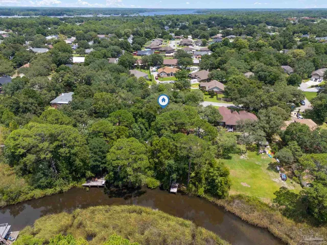 an aerial view of a house with garden space and street view