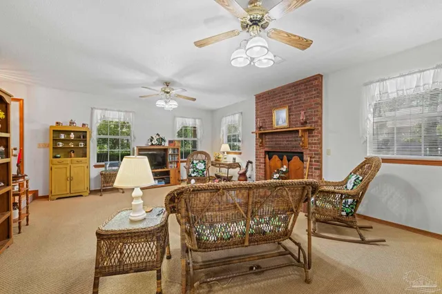 a living room with furniture a fireplace and chandelier