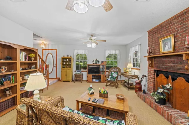 a living room with furniture fireplace and rug
