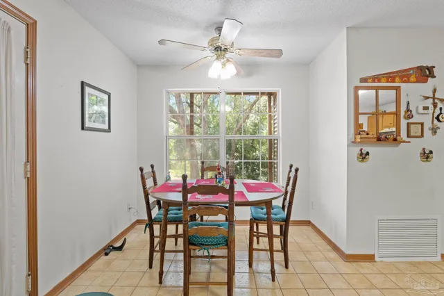 a view of a dining room with furniture and a chandelier