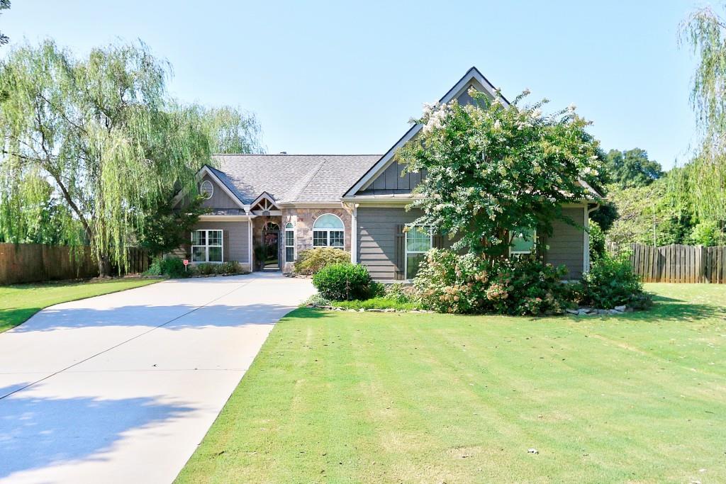 108 Gann Court Winder, GA 30680 - Photo 1 of 1 Cratsman style ranch with Huge bonus on over 2 acres of fenced property. Stone front, hardy plank siding and cedar accent above front door.