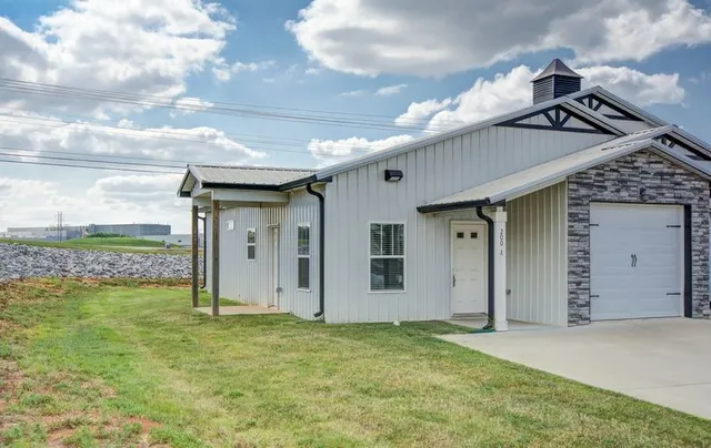 a view of a house with a backyard and a garage
