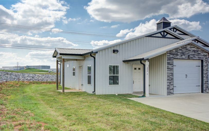a view of a house with a backyard and a garage